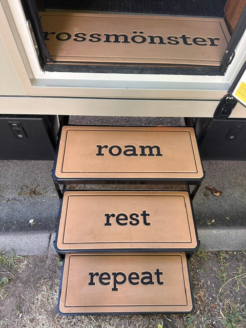 Rossmönster Havn and Loft RV entry steps featuring tan non‑slip pads with black metal frames, leading into the camper doorway