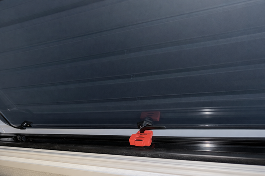 Red ASA EKKO window stay installed on Winnebago EKKO window frame holding the swing window open for ventilation