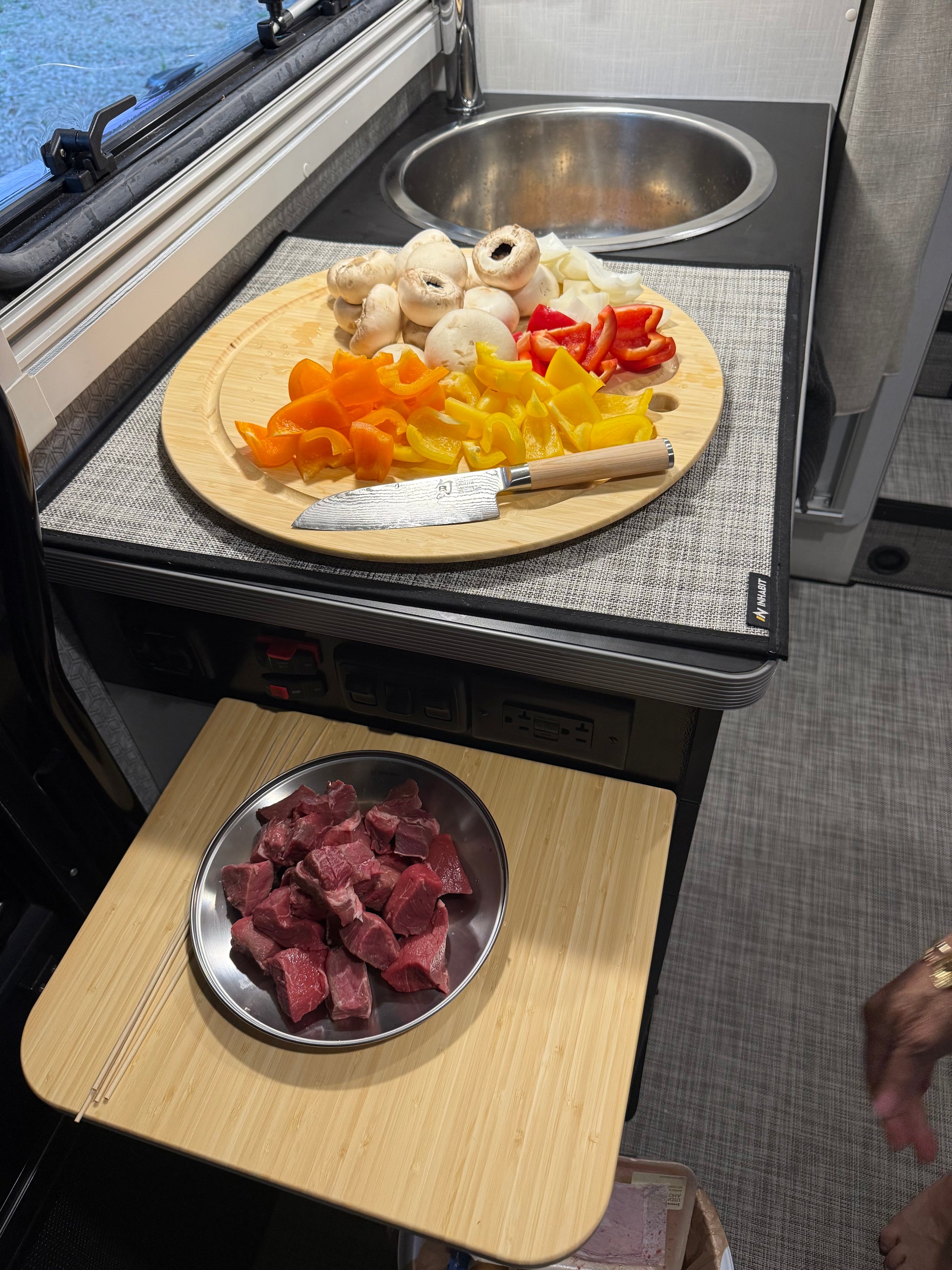 GripTurf Prep Pro and flip‑up counter in the EKKO kitchen holding vegetables, mushrooms, and meat during meal prep.