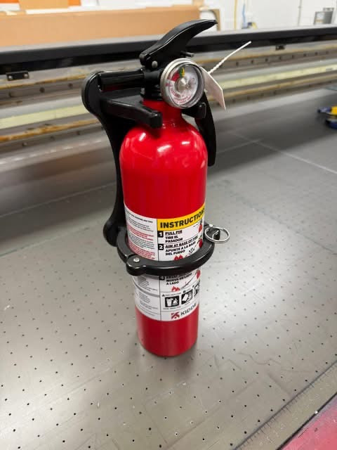 GripTurf RV fire extinguisher mount with extinguisher shown in a clean studio shot.