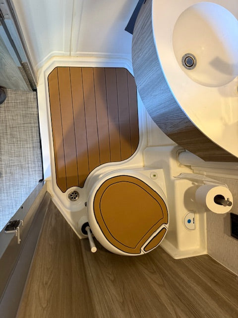 GripTurf teak‑over‑black shower mat set installed in a Winnebago EKKO wet bath.