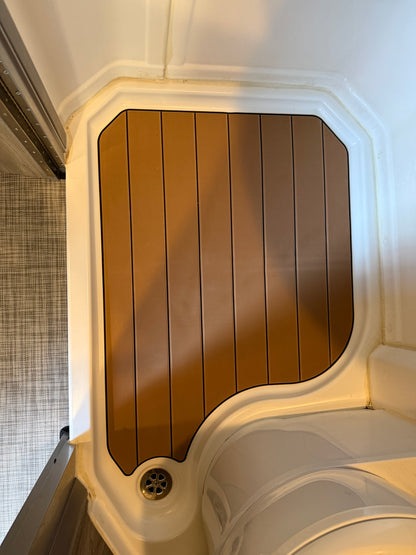 GripTurf Shower Mat installed in the Winnebago EKKO wet bath, shown in teak‑over‑black for a custom fit.