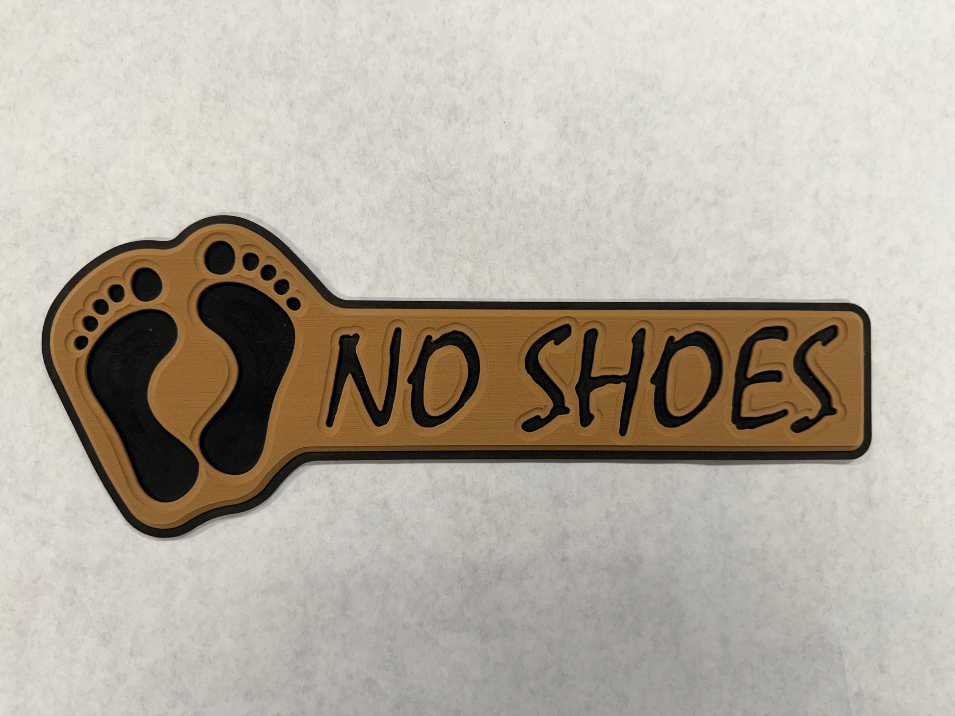 GripTurf No Shoes Pad in teak over black with routed NO SHOES lettering and 3M adhesive.