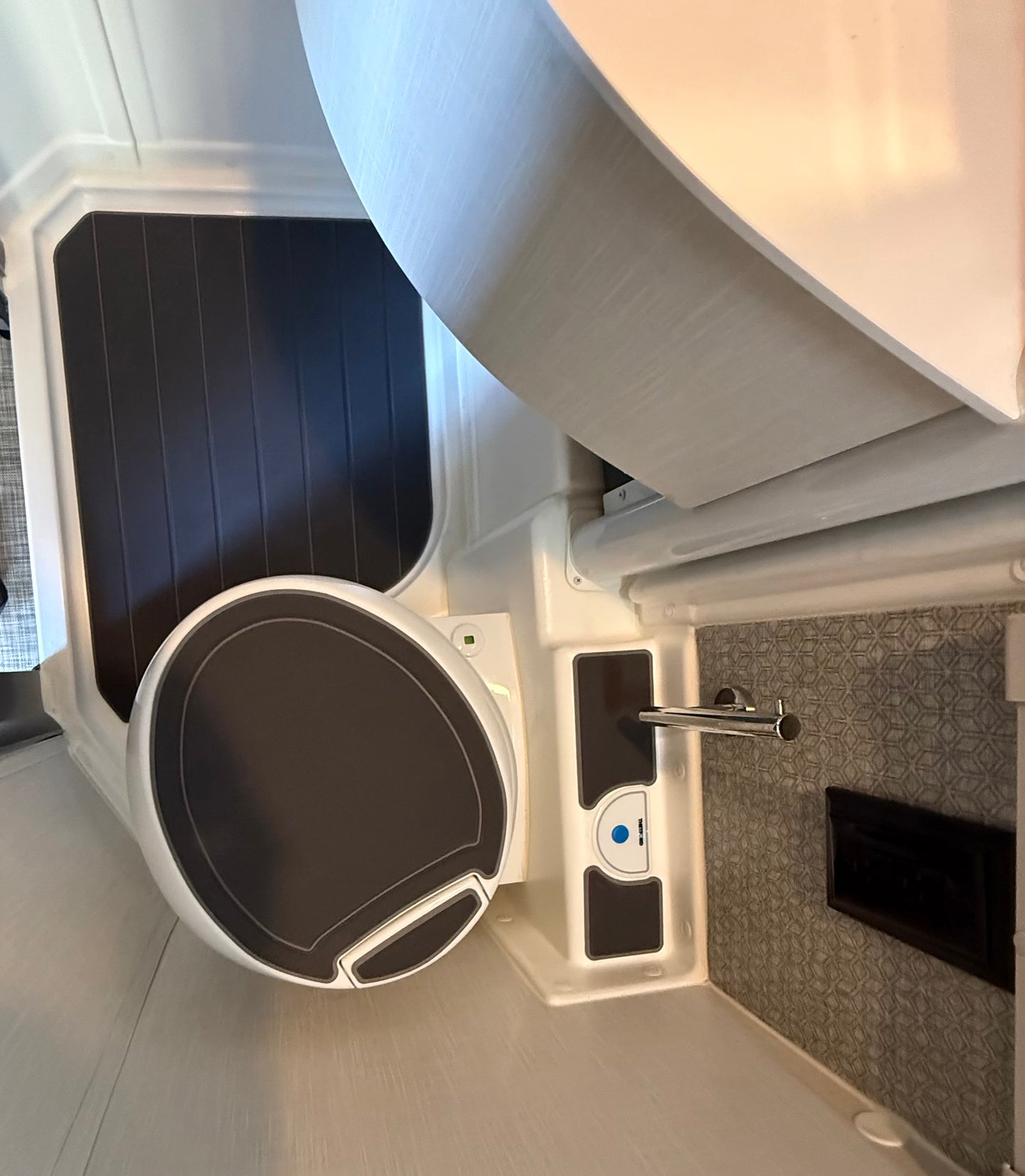 GripTurf steel‑grey‑over‑black shower mat set installed in a Winnebago EKKO wet bath.