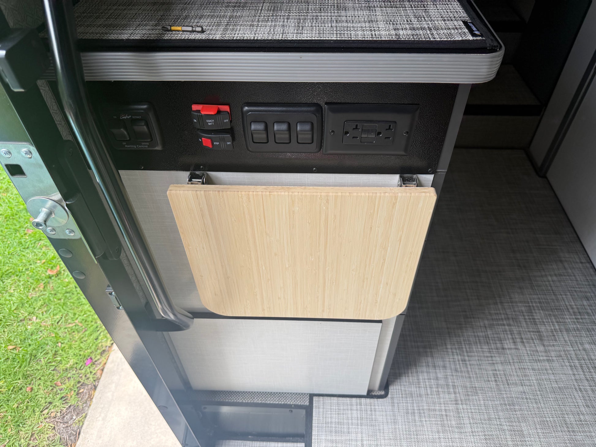 GripTurf Natural Bamboo Folding Countertop Extension installed in the Winnebago EKKO, shown in the down storage position.