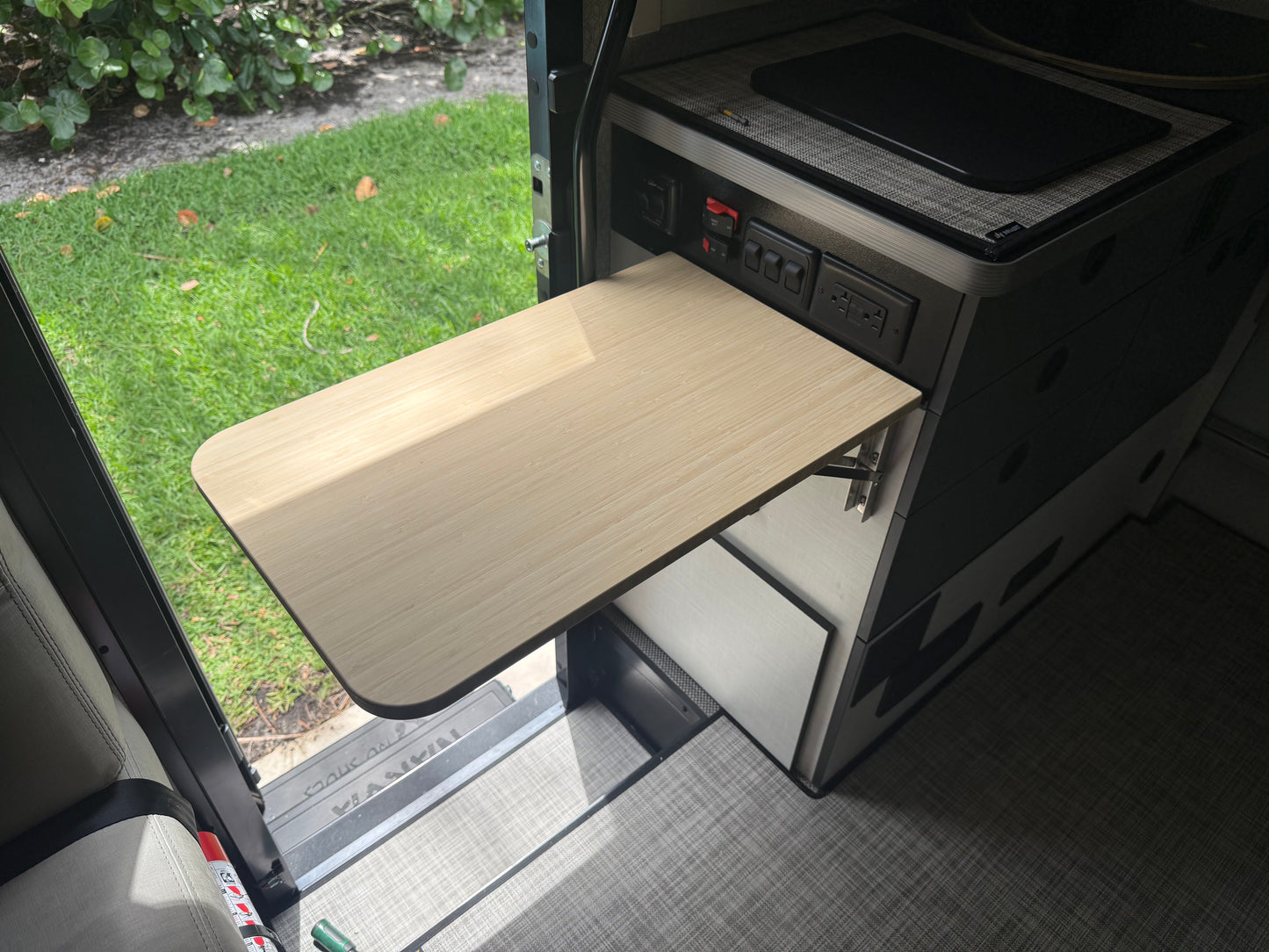 GripTurf 24-inch Natural Bamboo Folding Countertop Extension installed in the Winnebago EKKO, shown in the upright position.