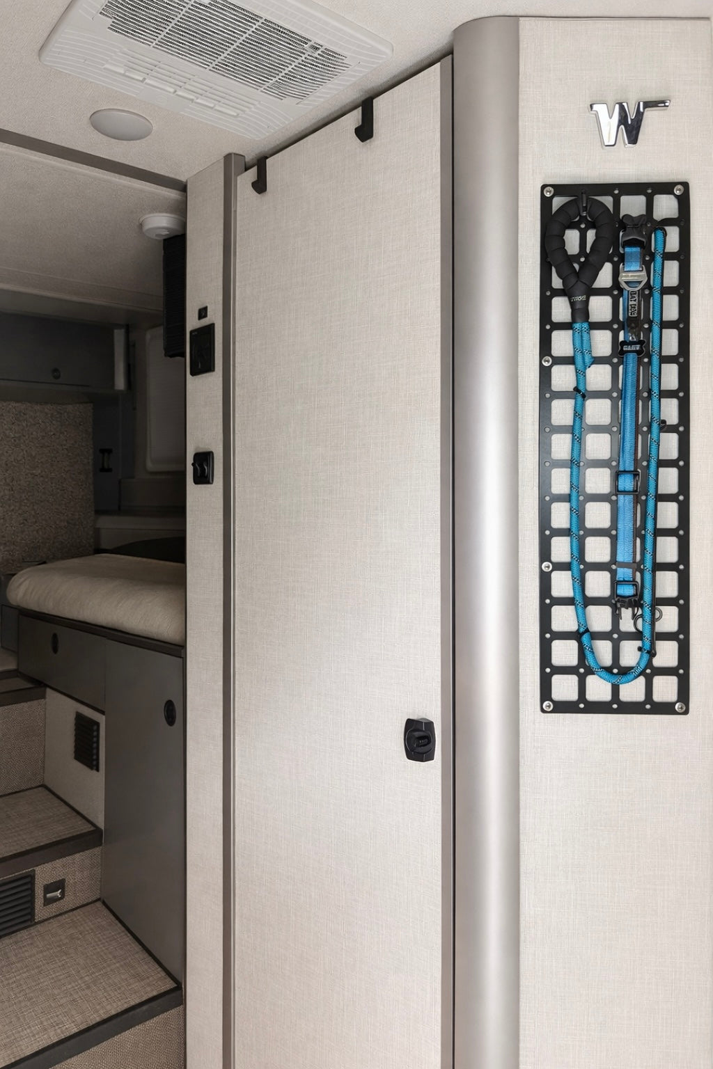 GripTurf EKKO Over‑Door Hook 2‑Pack in black mounted on the Winnebago EKKO bathroom door.