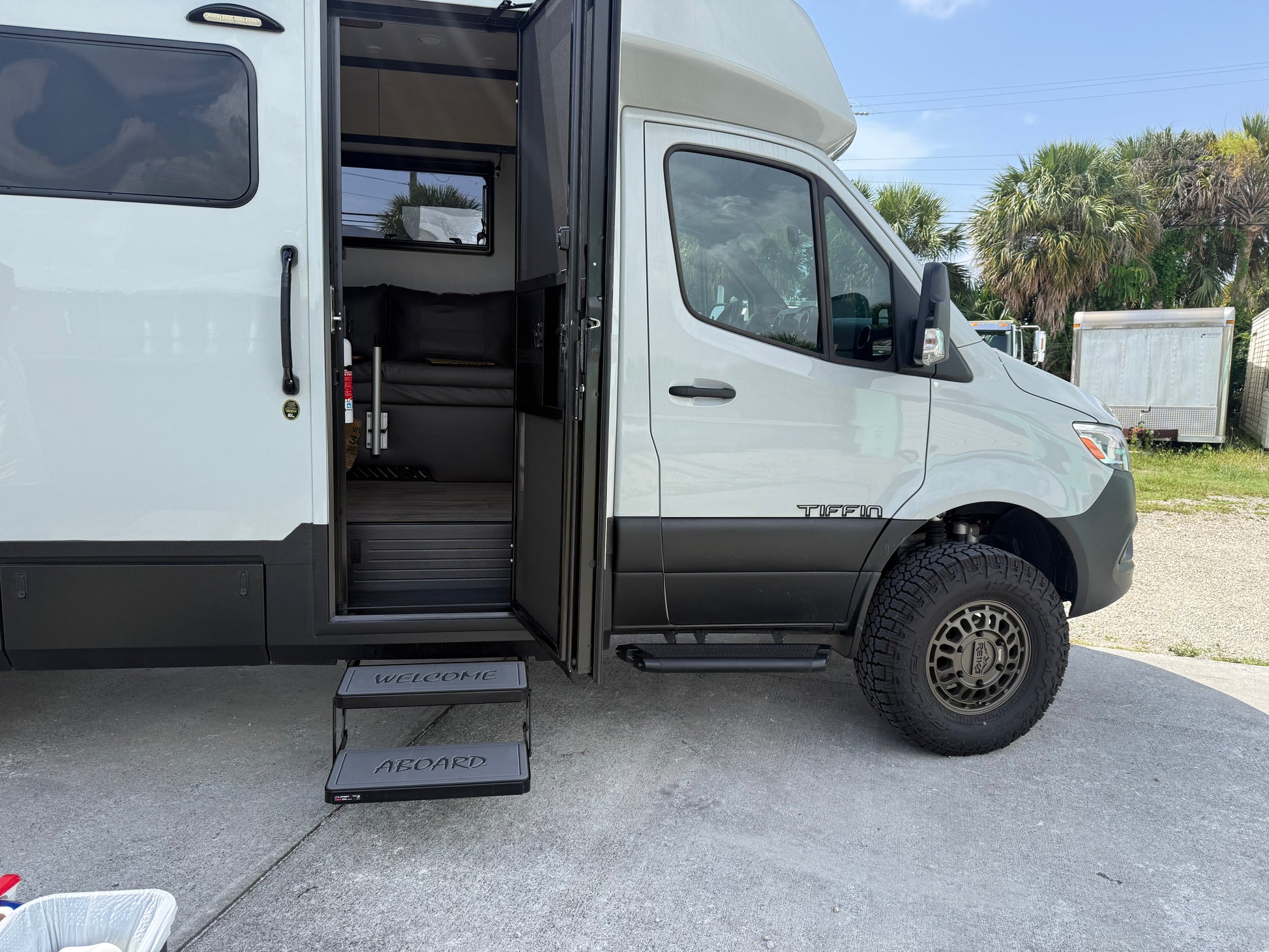 Tiffin Open Trail RV upgraded step pads with high‑traction ‘WELCOME’ and ‘ABOARD’ inserts at the entry door.”