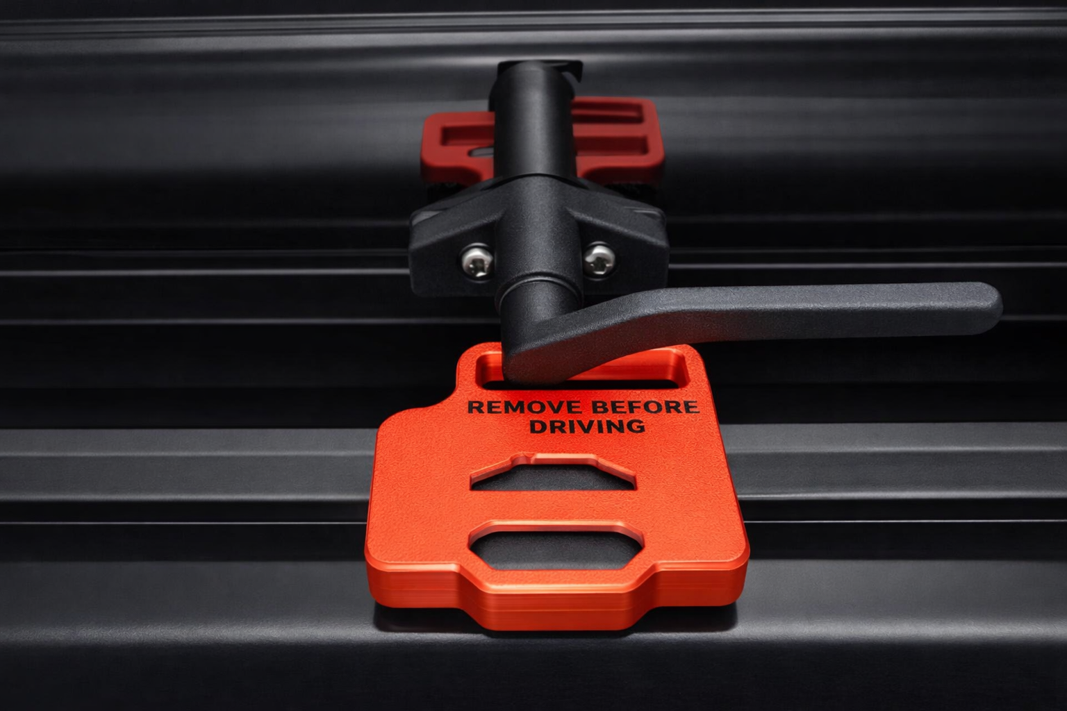 Red “Remove Before Driving” EKKO window stay installed on RV window frame for secure hold‑open use